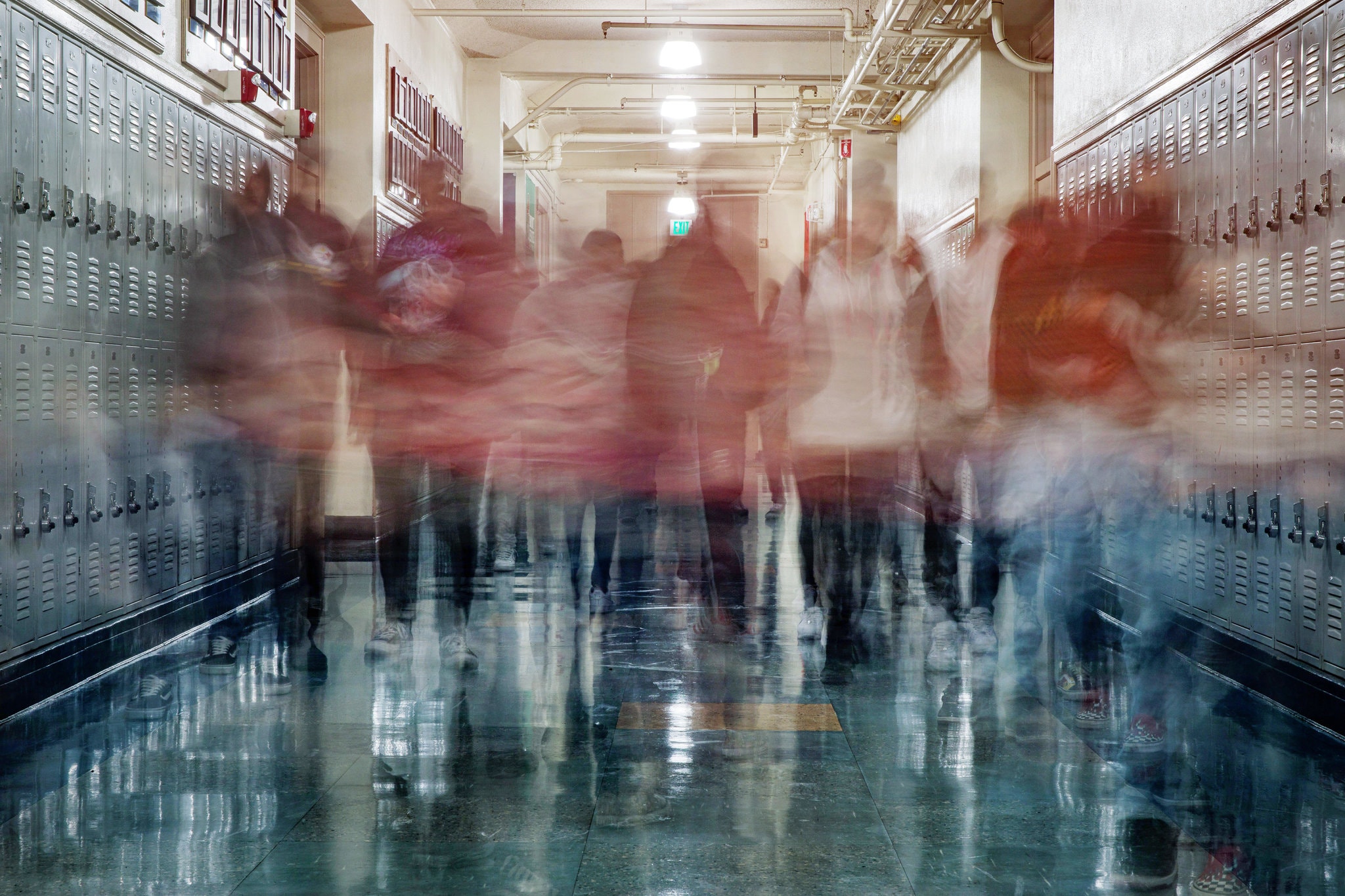 Photo of students disappearing from a school hallway; Damon Winter/The New York Times